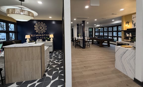 A modern interior with a reception desk and a dining area.