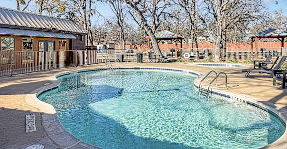 A round above ground pool with a metal fence around it.