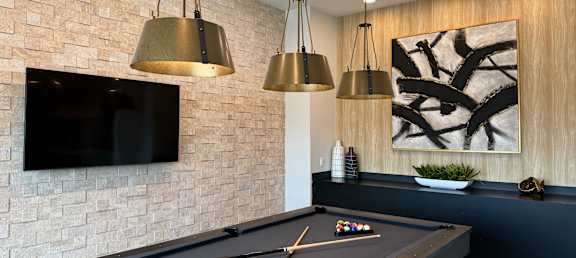 a games room with a pool table and a television
