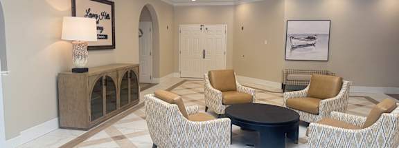 A living room with a checkered floor and a skylight. at Legacy Hills at Poway 55+ Apartments, California