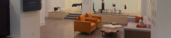 A modern living room with a television, couches, and a rug.