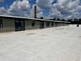 A building with a flat roof and a chimney.