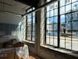 A room with a large window showing a street view outside.
