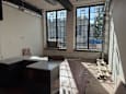 A room with a large window and a counter is under construction.