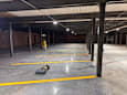 A large, empty warehouse with yellow lines on the floor.