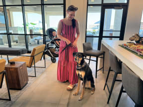 a woman in a pink dress with her dog