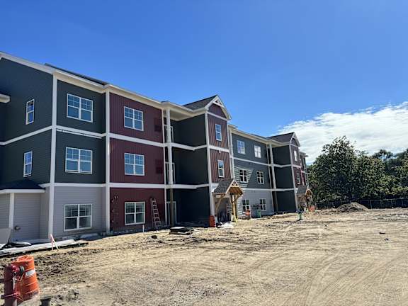 A row of new townhouses are under construction.