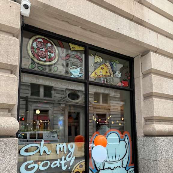a window of a restaurant on the side of a building