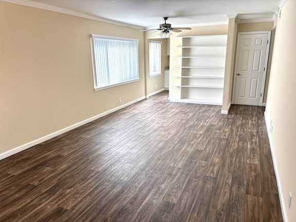 A room with wooden flooring and a ceiling fan.