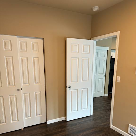 A white door is on the bottom and a white door with a window above it.