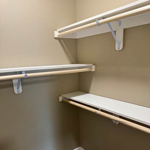 A white ladder is leaning against a wall.