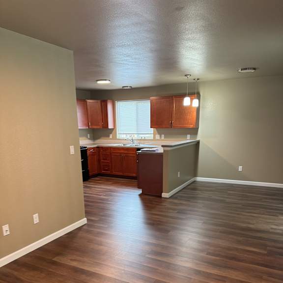 A room with a wooden wall and a white table.