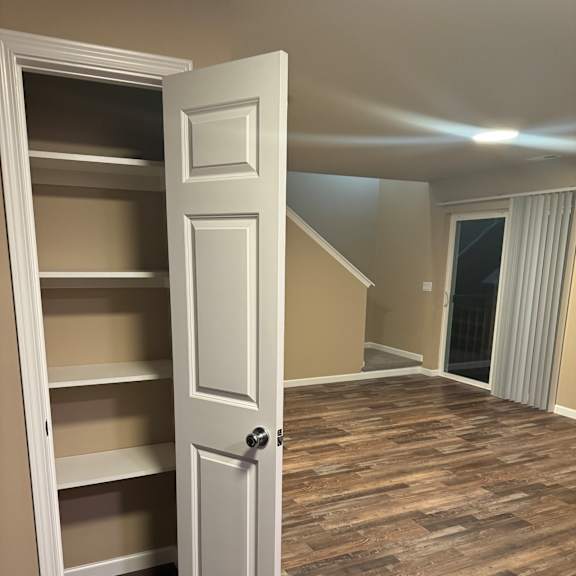A white door with a handle is open.