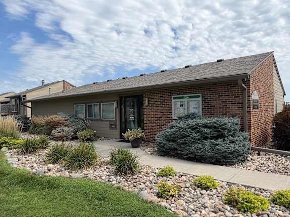 Fox Run Apartments leasing office in Omaha, Nebraska with gray roof and front door
