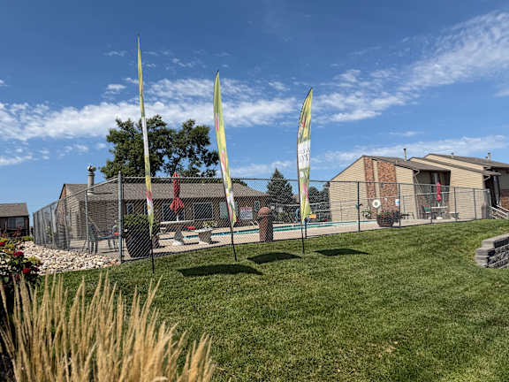 Fox Run Apartments building with a Now Leasing flag in Omaha, Nebraska