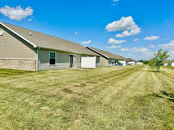 a row of houses with grass in front of them at Hawthorne Properties in Lafayette, IN 47905