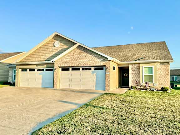 a house with a driveway and a garage door at Hawthorne Properties in Lafayette, IN 47905