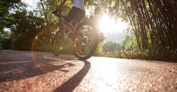 a person riding a bike on a road