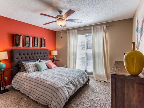 a bedroom with a bed and two lamps  at Quail Ridge Apartment Homes, Bartlett, Tennessee, 38135