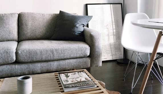 a living room with a gray couch and a coffee table