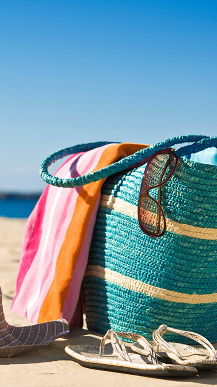 Lifestyle photo of beach bag, hat and sunglasses at Villa Hermosa, Miami, FL, 33174
