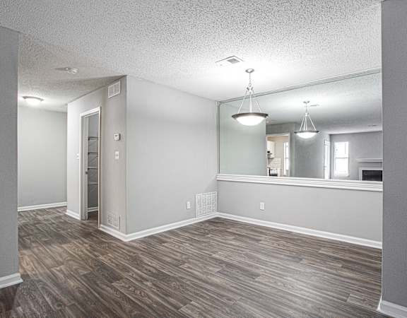 an empty living room with a hardwood floor