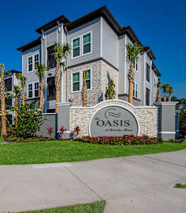 A stone building with a palm tree in front.