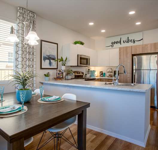 an open kitchen and dining area with a table and chairs