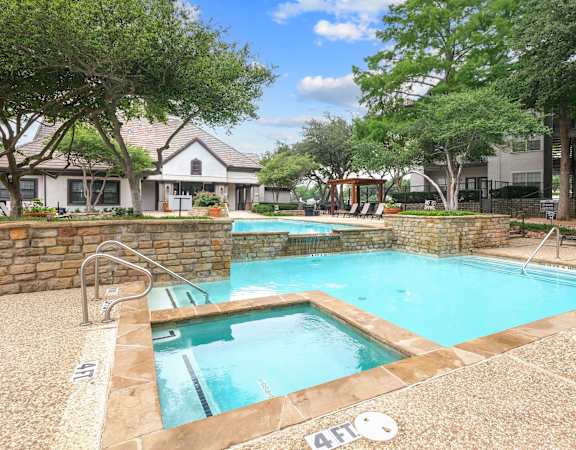 Pool with spa by the leasing office at Jefferson Place apartments in Irving, TX