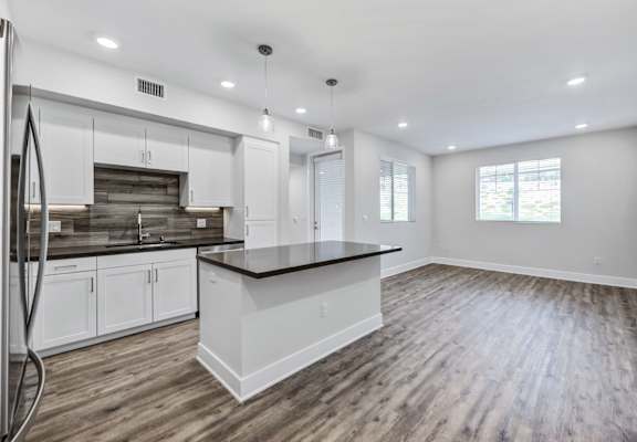 a kitchen and living room in a new home