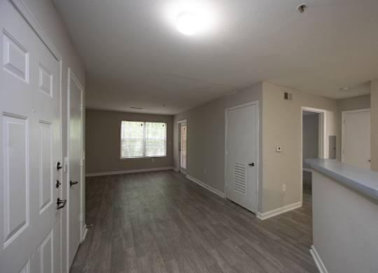 an empty living room and kitchen in a new home at Magnolia Pointe Apartments in Duluth, GA