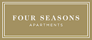 A sign that says "FOUR SEASONS APARTMENTS" on a beige background.