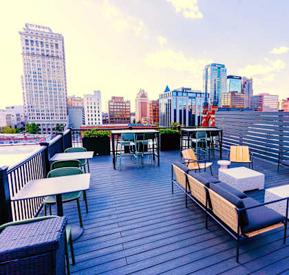 a rooftop patio with a city skyline in the background