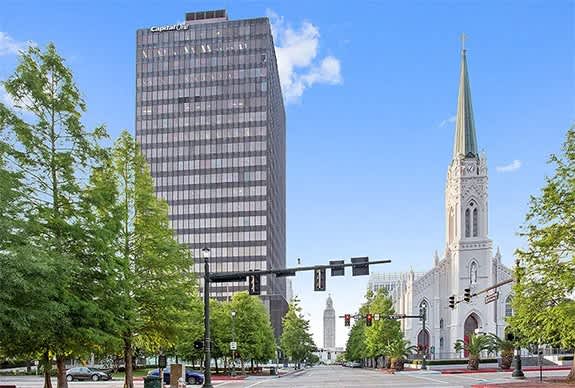a city street with a church and a tall building