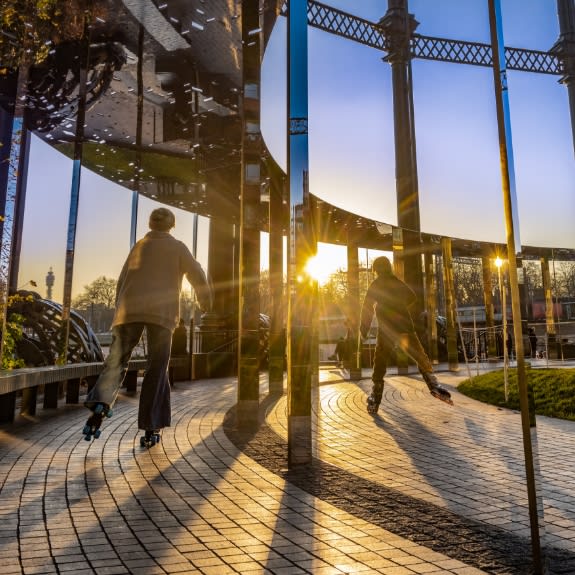 people rollerblading in the park at sunset