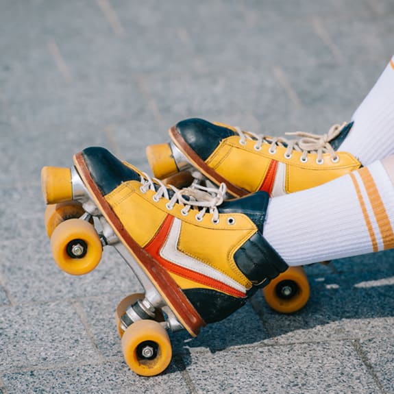 a pair of yellow and black skate shoes on a skateboard