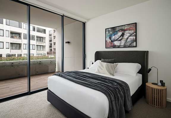 a bedroom with a large bed and a balcony