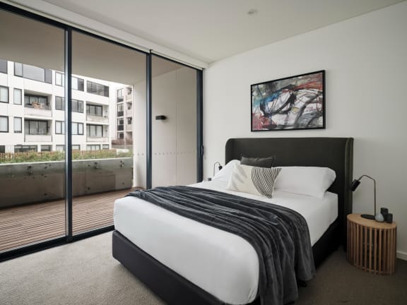 a bedroom with a large bed and a balcony