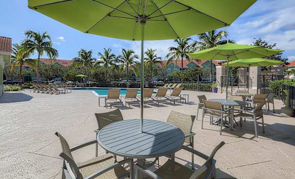 Poolside tables and umbrellas at Monterra at Bonita Springs, Bonita Springs, Florida