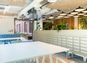 Thumbnail 6 of 8 - a communal area with tables and chairs in a workplace