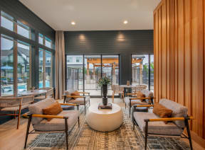 a conference room with a long wooden table and chairs and a wall of logs