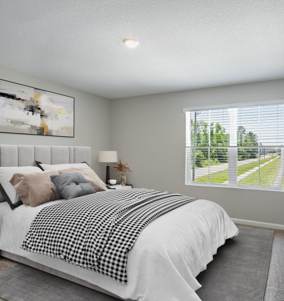 an empty bedroom with a bed and a window