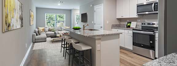 an open kitchen and living room with an island and stools