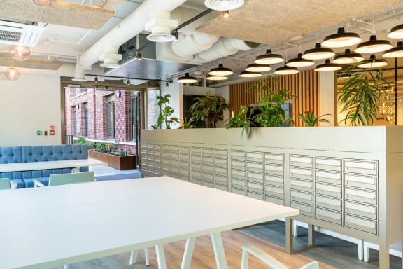 a communal area with tables and chairs in a workplace