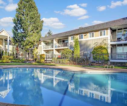 A swimming pool in front of apartment buildings.