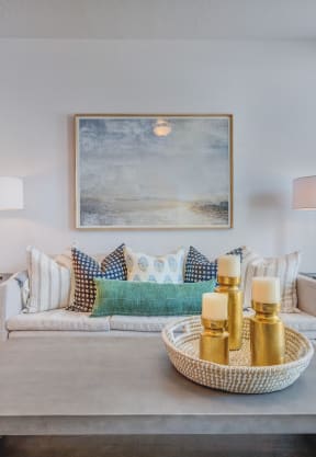 a living room with a couch and a table with candles