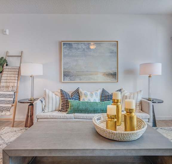 a living room with a couch and a table with candles