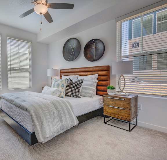 a bedroom with a bed and a ceiling fan