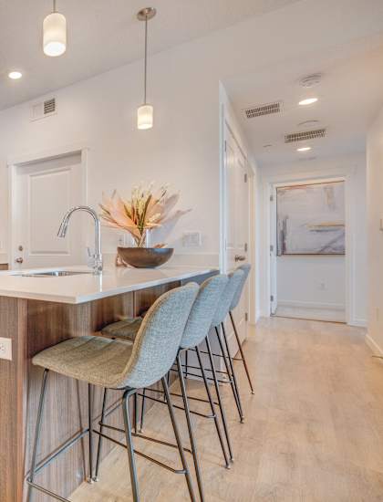 a kitchen with stainless steel appliances and an island with bar stools