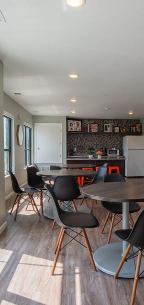 a dining room with a table and chairs and a kitchen with a large window